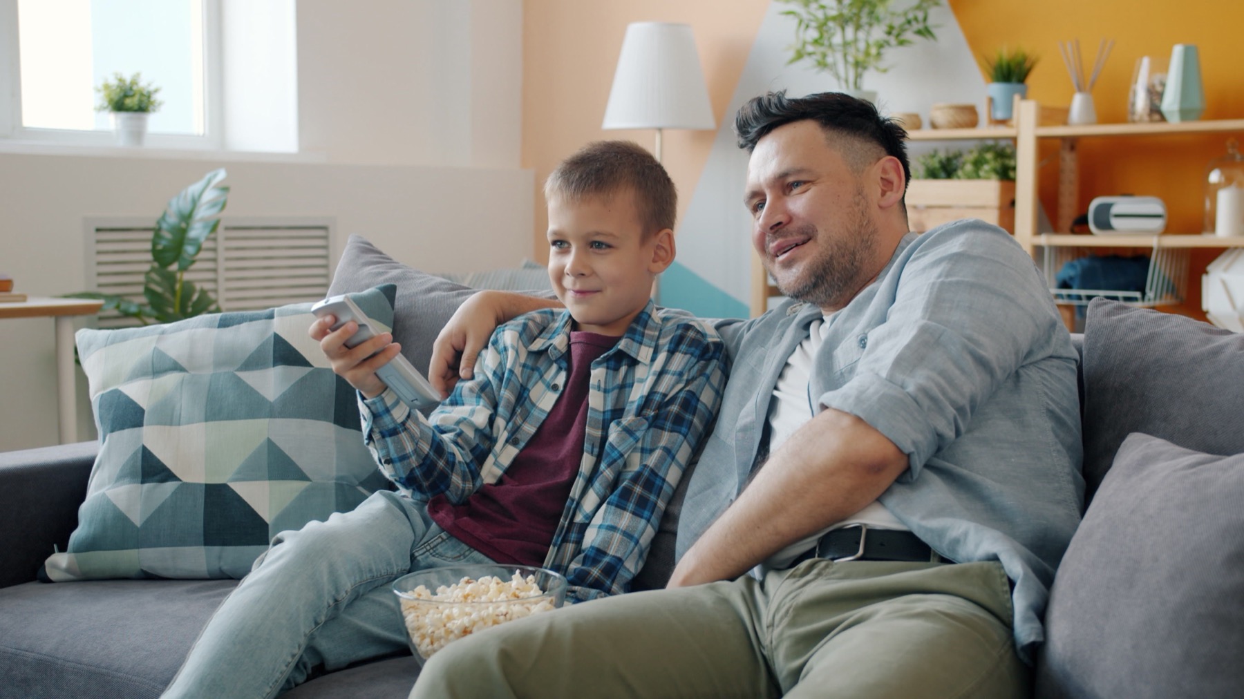 Family watching television in the living room