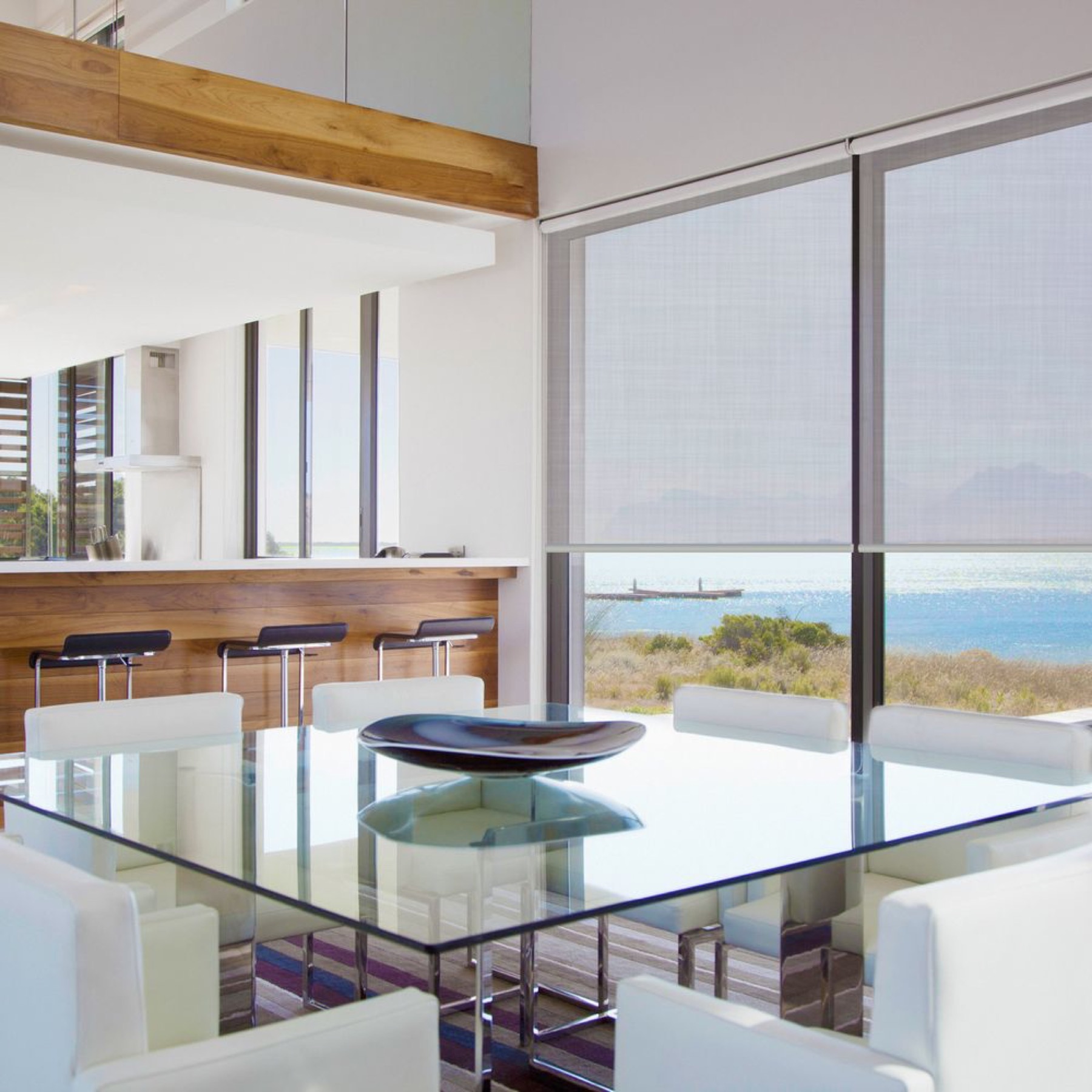 Motorised shades across a wall of glass